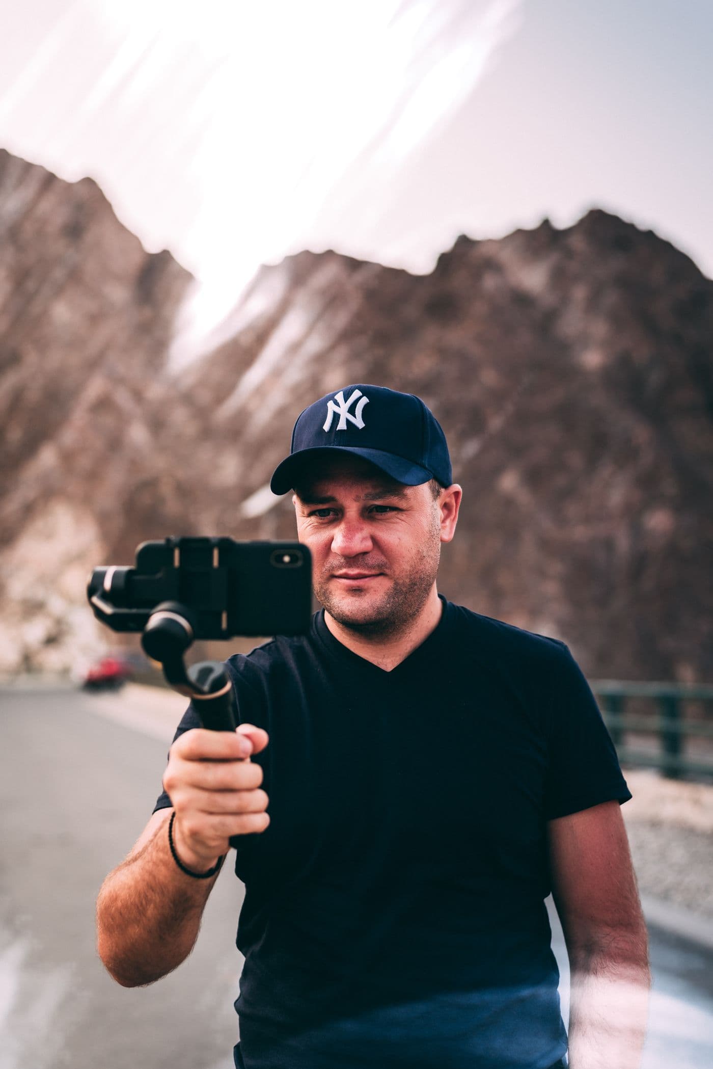 A creator films in the mountains with a phone stabiliser